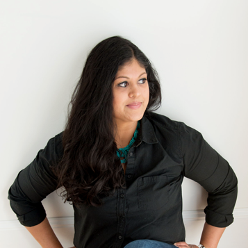 Amisha Patel Sitting on floor looking away