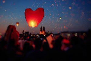 Red heart lantern lit and released into the sky